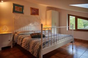 a bedroom with a bed with a metal bed frame at Villa Failla in Castelbuono