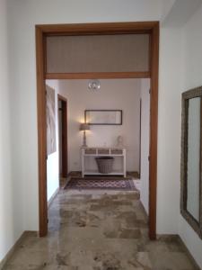 un couloir avec une porte s'ouvrant sur une chambre dans l'établissement B&Be Home, à Tollo