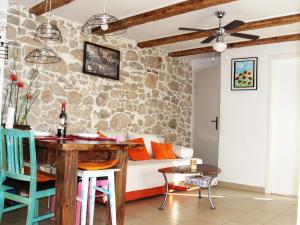 a living room with a table and a couch at Mimi in Jadranovo
