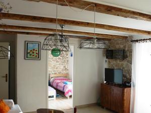 a bedroom with a bed and two pendant lights at Mimi in Jadranovo
