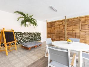 a dining room with a white table and chairs at Lightbooking Casa Maye Tenerife in Güimar