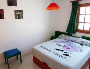 a small bedroom with a bed with a hello kitty blanket at Lightbooking Los Lagos El Cotillo in Cotillo