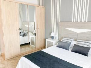 a bedroom with a bed and a large mirror at Lightbooking Aloe Las Playitas Beach in Las Playitas