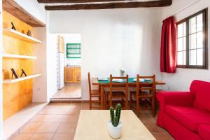 a living room with a red couch and a table at Lightbooking La Hoya Tenerife in Güimar