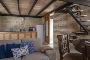 a living room with a couch and a brick wall at Casa Palacio De La Cruz in El Puerto de Santa María