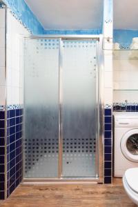 a shower in a bathroom with a washing machine at Lightbooking La Hoya Tenerife in Güimar