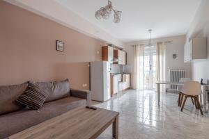 a living room with a couch and a table at Central apartment with parking in Larisa