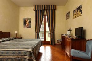 Postel nebo postele na pokoji v ubytování Hotel Bologna