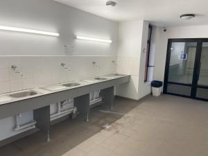 a row of sinks in a public bathroom at nuit insolite sur un petit voilier in La Rochelle