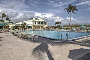 a large swimming pool next to a white building at Sunny Ocean Village Condo with Community Pool! in Fort Pierce