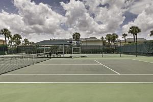 a tennis court with a net on top of it at Sunny Ocean Village Condo with Community Pool! in Fort Pierce