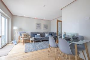 a living room with a couch and a table at Harbour View Apartment at Royale Court Apartments Portrush in Portrush