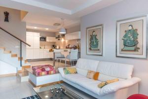 sala de estar con sofá blanco y cocina en Lightbooking piscina privada Salobre Golf, en San Bartolomé