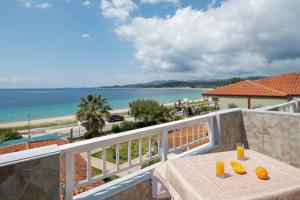 a table on a balcony with a view of the ocean at casamariatoroni in Toroni