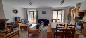 a kitchen and living room with a table and chairs at La Turra in Lanslebourg-Mont-Cenis