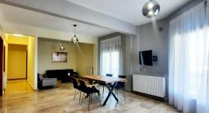 a living room with a dining room table and chairs at Armenos Family in Ierissos