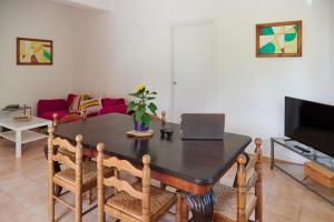 a living room with a table with a laptop on it at Villa Failla in Castelbuono