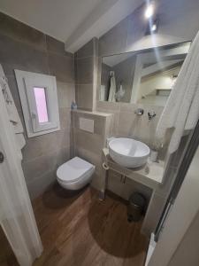 Un baño con un inodoro blanco y un lavabo. en The Fox Cove, en Roma