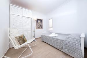 una camera da letto con un letto, una sedia e una finestra di Dream Papagayo a Playa Blanca