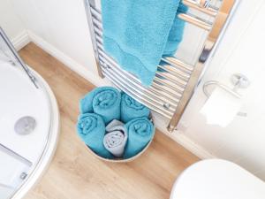 a bathroom with a basket of towels and a sink at Gwithian Shepherds Hut in Hayle