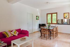 a living room with a red couch and a table at Villa Failla in Castelbuono