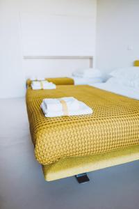 a wicker bed with towels on it in a room at VILLA ZEROU in Kojsko +36 photos