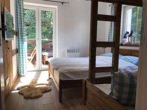 a bedroom with two bunk beds and a balcony at Horský apartmán Vrátna-Saška in Terchová