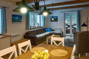 a living room with a table and a couch at Horský apartmán Vrátna-Saška in Terchová