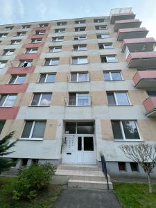 a tall building with a white door in front of it at Modern Central Apartment in Nitra