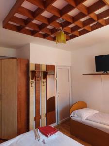 a room with two beds and a tv on the ceiling at Mountain View in Buşteni