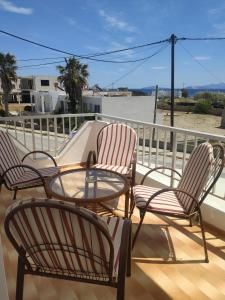 eine Terrasse mit 3 Stühlen und einem Tisch auf dem Balkon in der Unterkunft Paradise in Kefalos