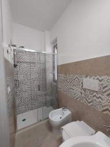 a bathroom with a shower and a toilet and a sink at B&B LA GIARA ART in Gallipoli