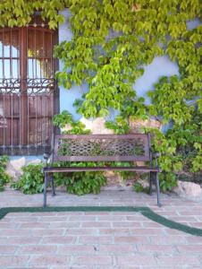 a wooden bench sitting in front of a building at El Quinto Pino Riópar in Riópar
