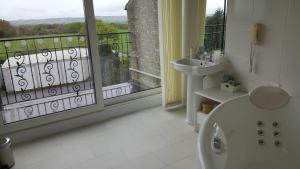 a bathroom with a tub and a sink and a window at The Wood Cottage in Scarborough