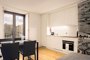 cocina con mesa y sillas en una habitación en oldcity design apartments, en Oporto