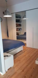 a bedroom with a bed and a wooden floor at MiniLoft Cattaneo in Monza