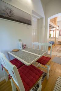 a dining room with a table with red cushioned chairs at A Lovely apartment near Railway station and Arena. in Tampere