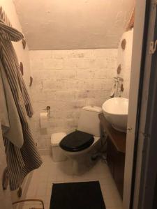 a small bathroom with a toilet and a sink at A Lovely apartment near Railway station and Arena. in Tampere