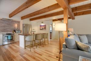 a kitchen and living room with a couch and a table at North Conway Townhome with Private Hot Tub and Deck! in North Conway