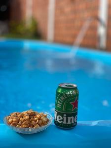 a can of beer sitting next to a bowl of nuts at Pousada vida nos lençóis in Barreirinhas