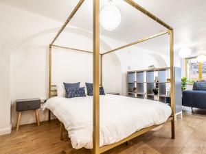 a bedroom with a four poster canopy bed at Pass the Keys Stylish and central character flat with courtyard in Exeter