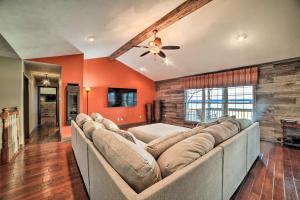 a large couch in a living room with orange walls at Peaceful Big Sandy Home with Deck on Kentucky Lake! in Big Sandy