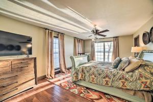 a bedroom with a bed and a flat screen tv at Peaceful Big Sandy Home with Deck on Kentucky Lake! in Big Sandy