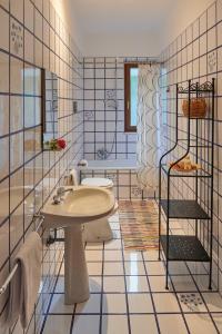 a bathroom with a sink and a tub and a toilet at Villa Failla in Castelbuono +41 photos