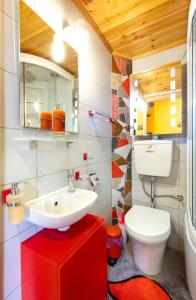 a bathroom with a white sink and a toilet at Zois Stone House in Kántanos