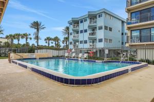 a swimming pool in front of a apartment building at First Street South Serenity in Jacksonville Beach