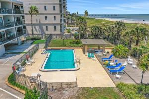 an aerial view of a swimming pool and the beach at First Street South Serenity in Jacksonville Beach