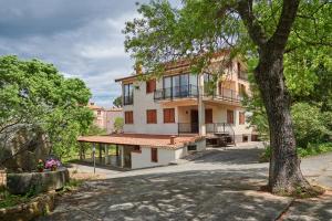 a large house with a tree in front of it at Villa Failla in Castelbuono