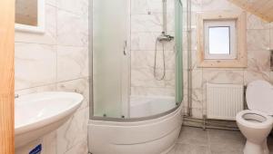a bathroom with a tub and a toilet and a sink at Шпінь 3 in Vorokhta +80 photos