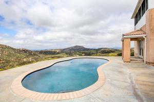a swimming pool on the side of a house at Mountaintop Ramona Home Private Pool, Near Lake! in Ramona